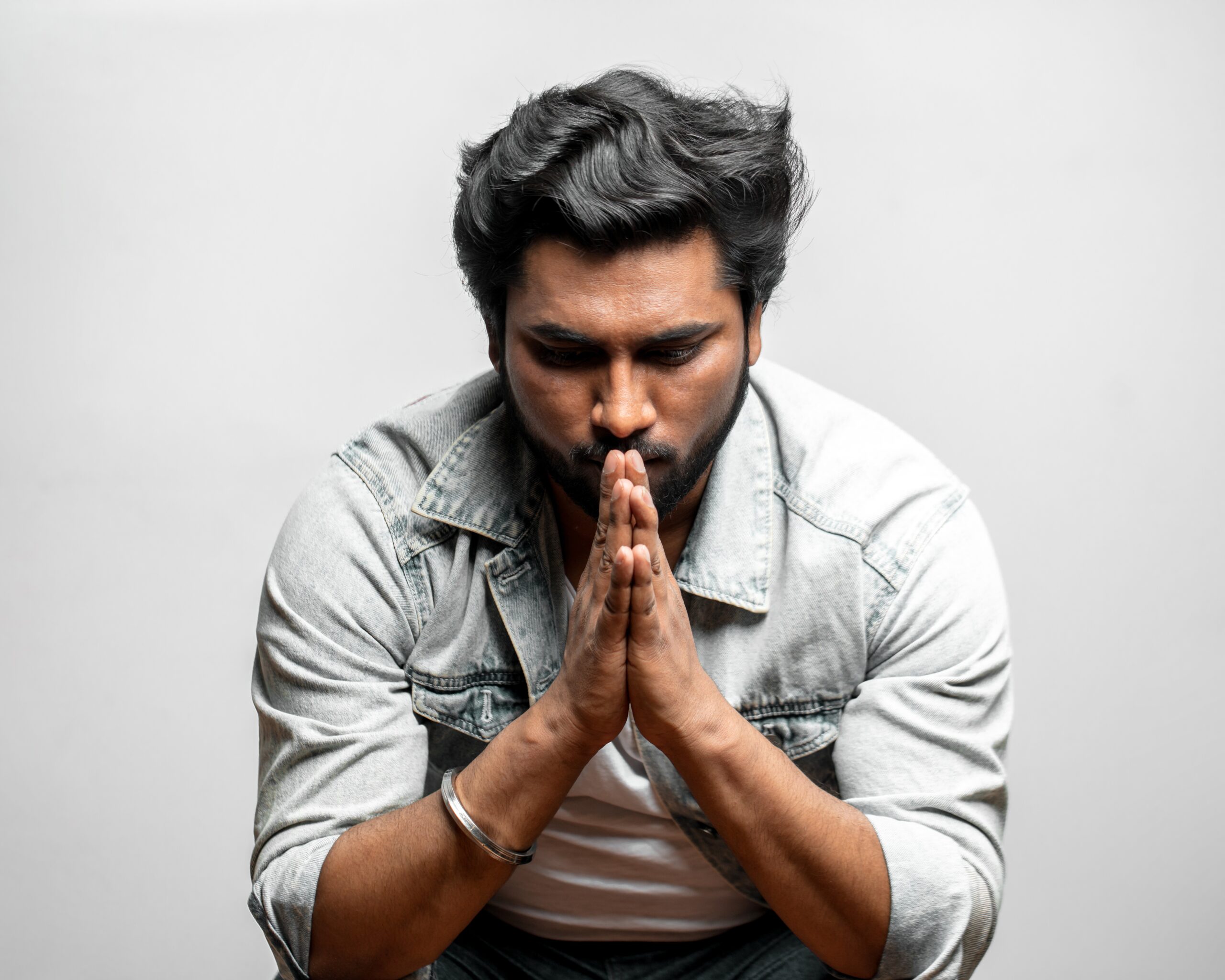 A man praying and thankful that he has found a place that offers Christian life coaching near Sedalia, MO